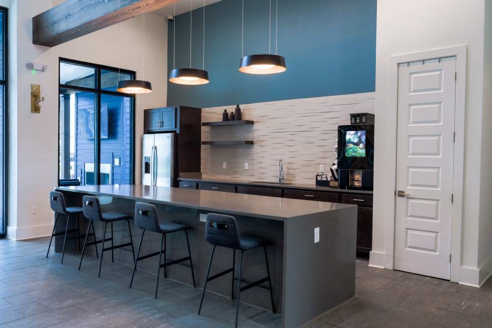 A modern kitchen with a bar area and a television.