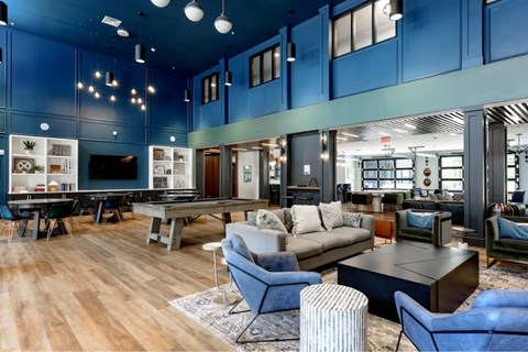 A modern living room with a pool table and a TV.