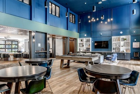 A resident clubhouse with ample seating and TVs.