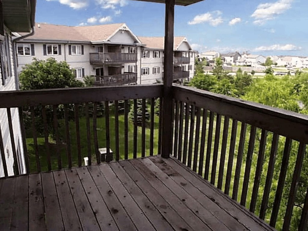 A balcony with a view of apartment buildings.