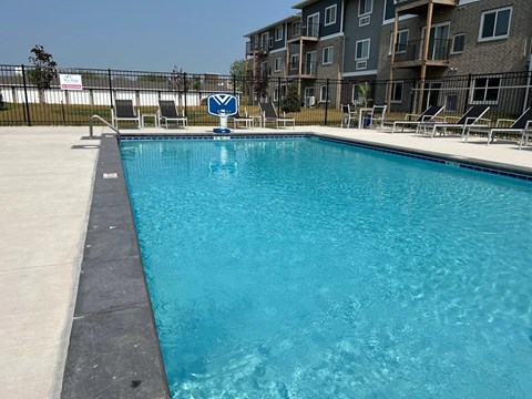 A swimming pool in front of a residential building.