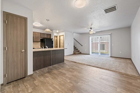 A spacious living room with a staircase leading to the upper floor.