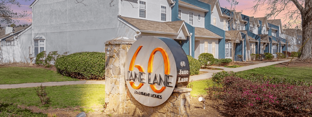 A sign for Lane Lane Estates is shown in front of a building.