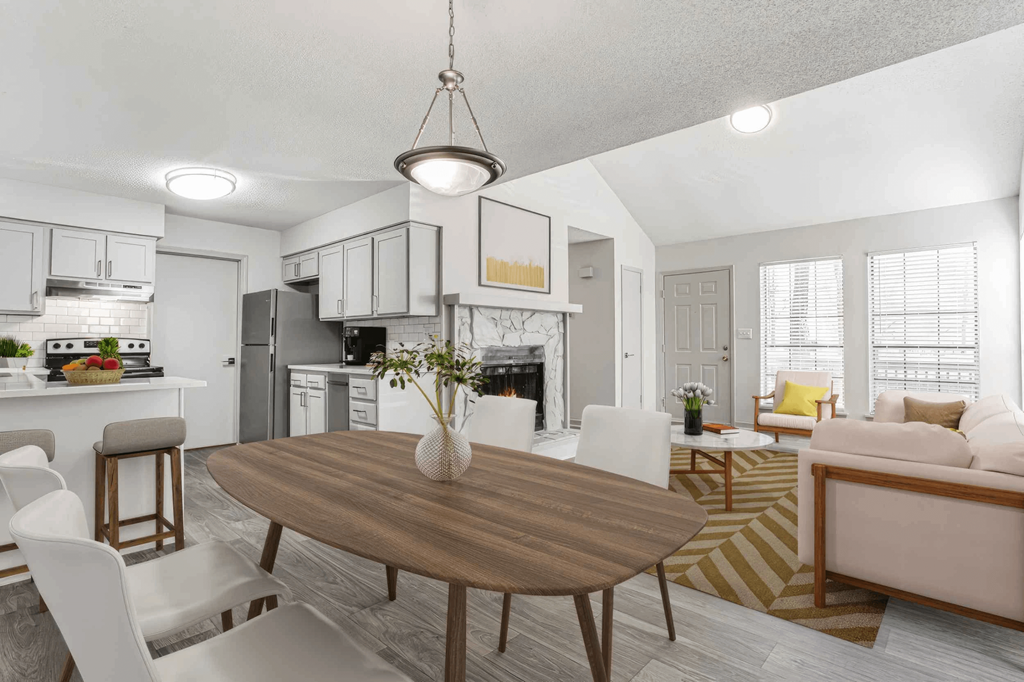 A modern kitchen with a dining table and chairs.