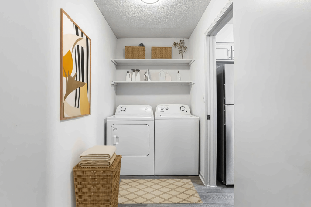 A small laundry room with a washer and dryer.
