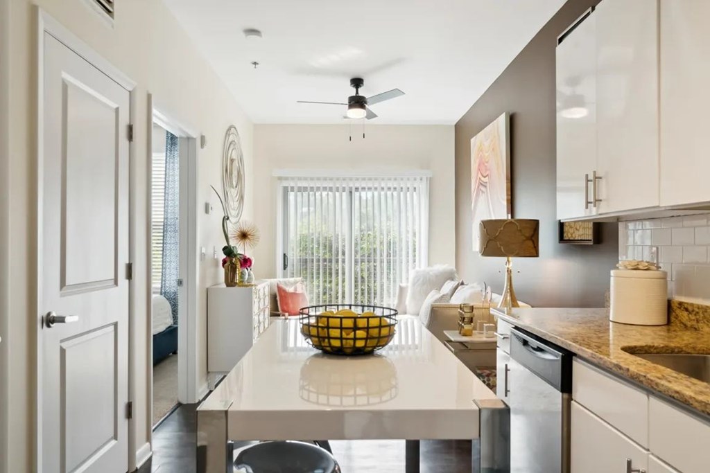 A kitchen with a white countertop and a ceiling fan.at Century Bridges, Virginia