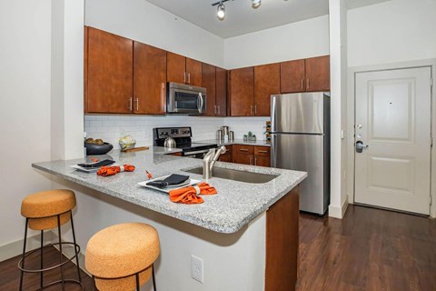 A kitchen with a refrigerator, microwave, and stove.at Century Cedar Hill, Cedar Hill, TX 75104