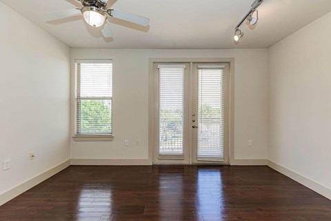 A room with a ceiling fan and sliding glass doors.at Century Cedar Hill, Cedar Hill, TX 75104