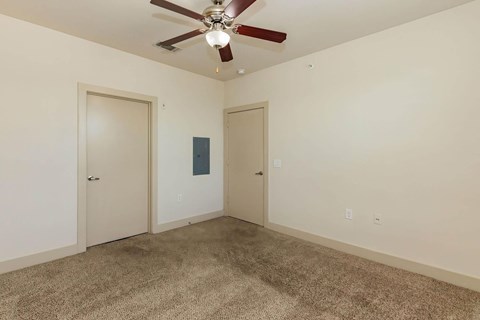 A room with a ceiling fan and carpeted floor.at Century Cedar Hill, Texas, 75104