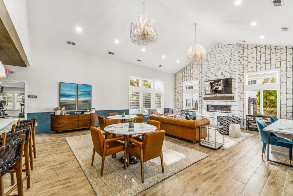 A modern living room with a dining table and chairs.