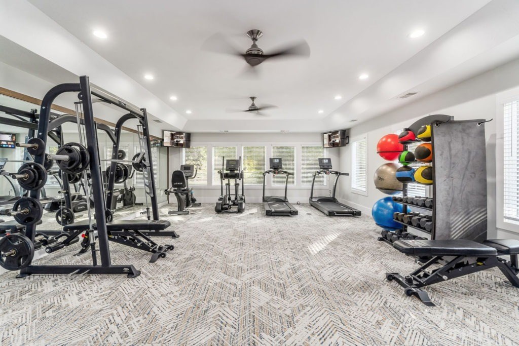 A spacious home gym with a variety of exercise equipment.