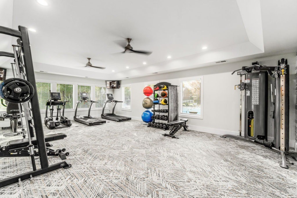 A spacious home gym with a variety of exercise equipment.