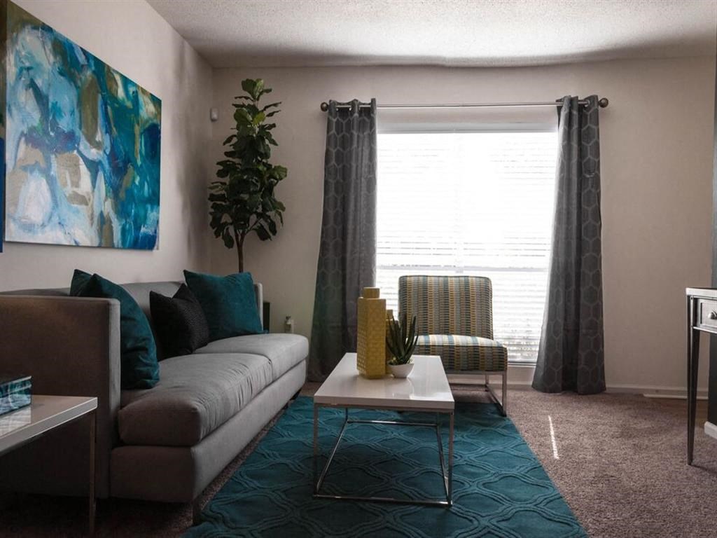 Living room with spacious windows and curtains at the Grove at St. Andrews, Columbia, SC