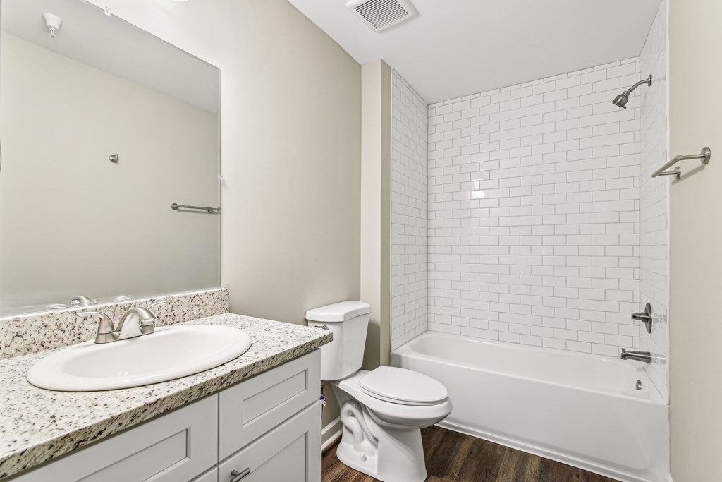 A white bathroom with a sink, toilet, and bathtub.