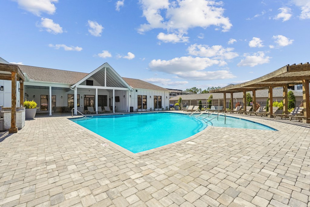 a large swimming pool in front of a house