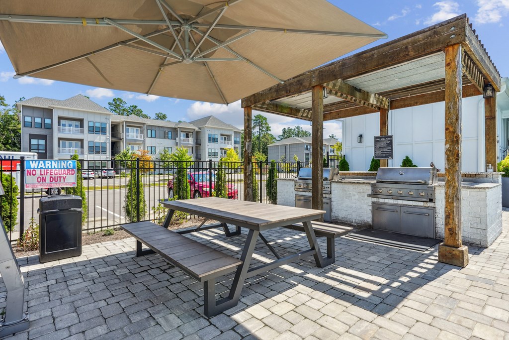 our picnic table and grill are outside our building with our apartments in the background