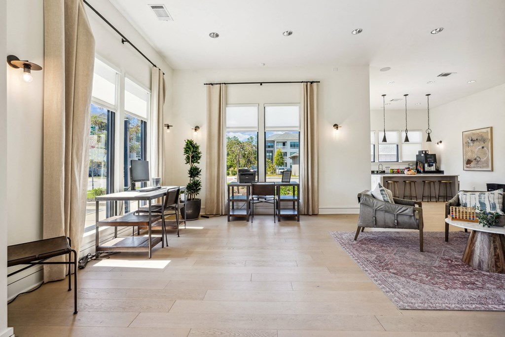 the living room and dining room of a house with large windows