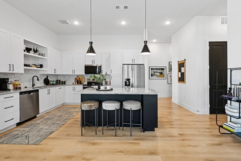 A kitchen with a bar stool and a counter.