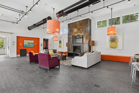 A living room with a fireplace and a painting on the wall.