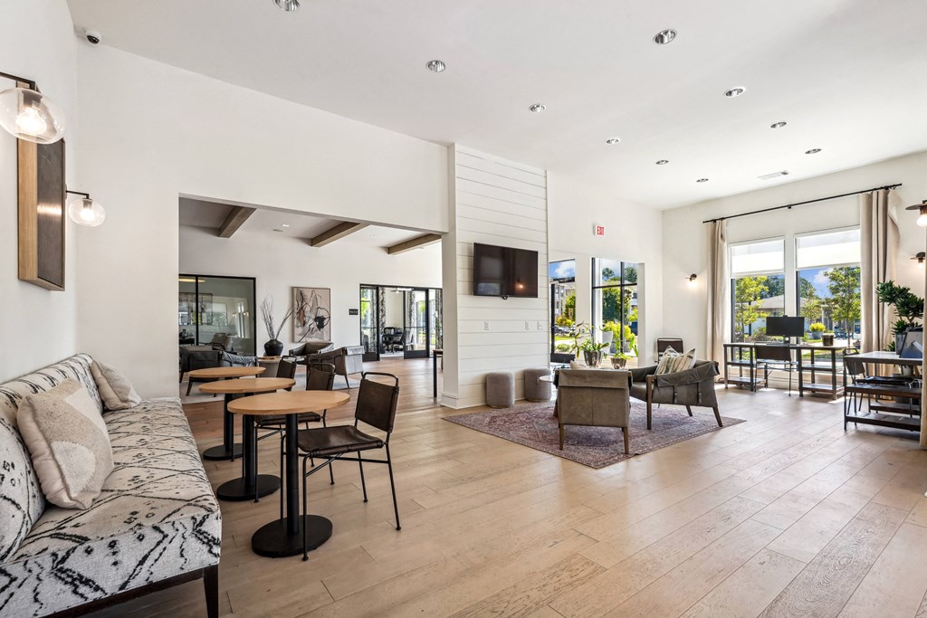 a living room with a couch and tables and a television