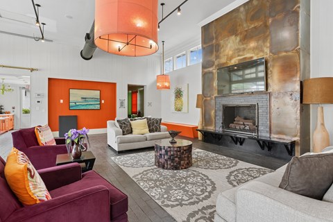 A living room with a fireplace and a painting on the wall.