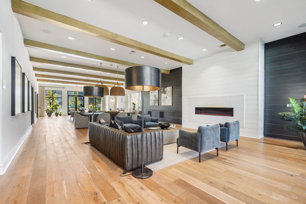 the living room has a fireplace and a large wood floor