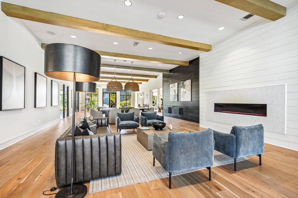 a living room with blue chairs and a fireplace