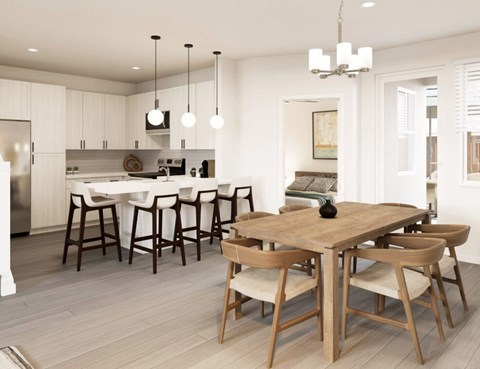 A modern kitchen with a dining table and chairs.