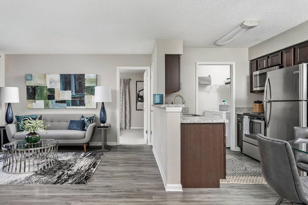 spacious living room and kitchen with stainless steel appliances  the enclave apartments