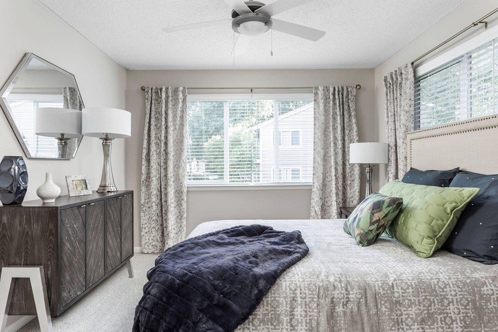 a bedroom with a large bed and a ceiling fan