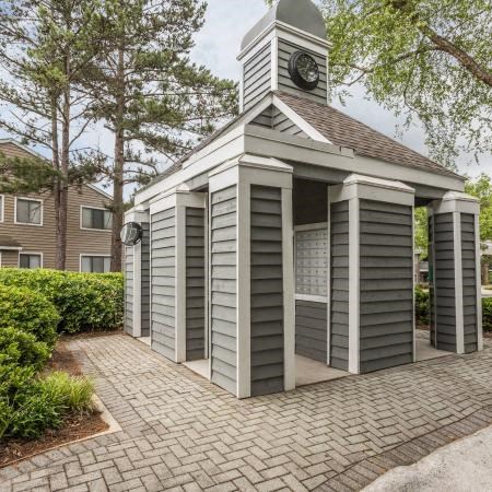 a small building with a clock on top of it