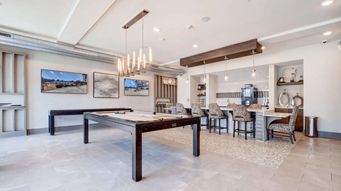 A modern dining room with a long table and chairs.