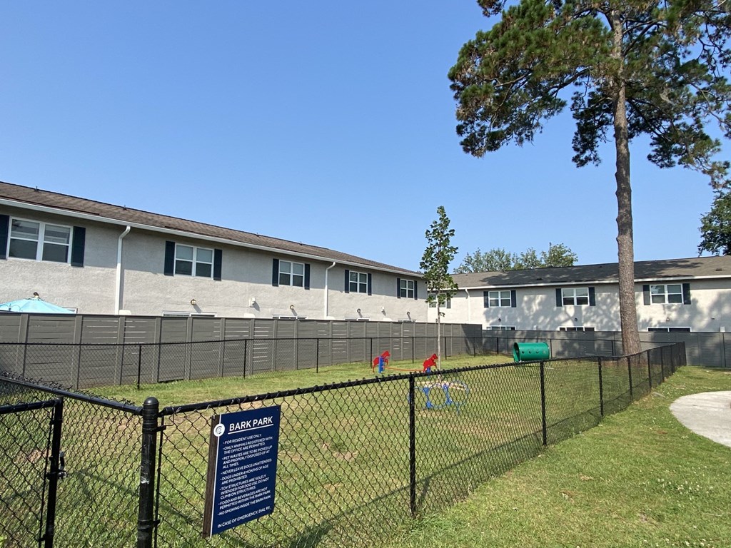 a dog park in front of an apartment building with a fence at Crescent Place Apartments, Savannah, 31419