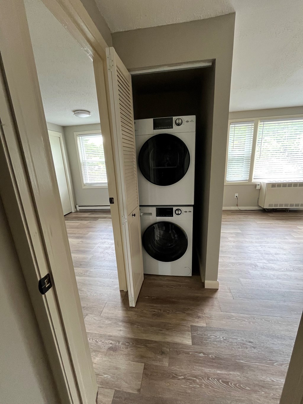 a front loading washer and dryer in a hallway of a home at Briarcliff at Quechee, Quechee