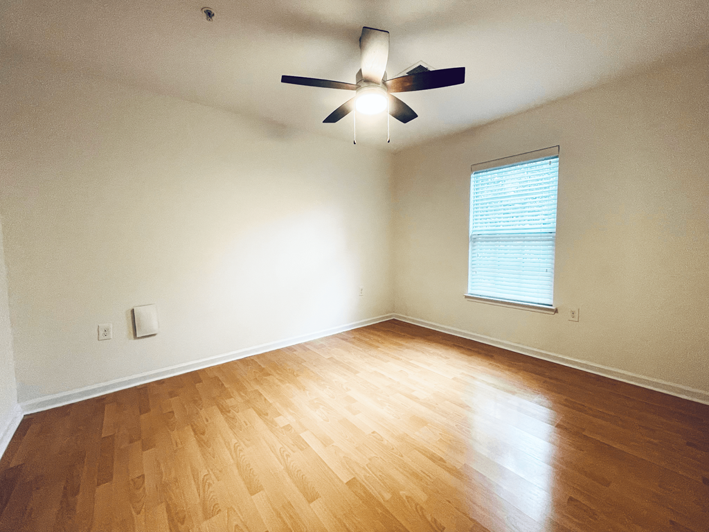 Bedroom with hardwood floors at Oasis at Twinwood in Wilmington, NC