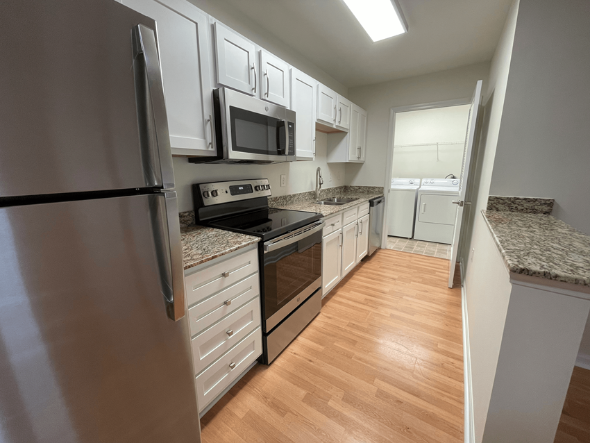 Kitchen with stainless steel appliances Kitchen with stainless steel appliances as Oasis at Twinwood in Wilmington, NC
