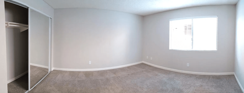 an empty room with white walls and a window