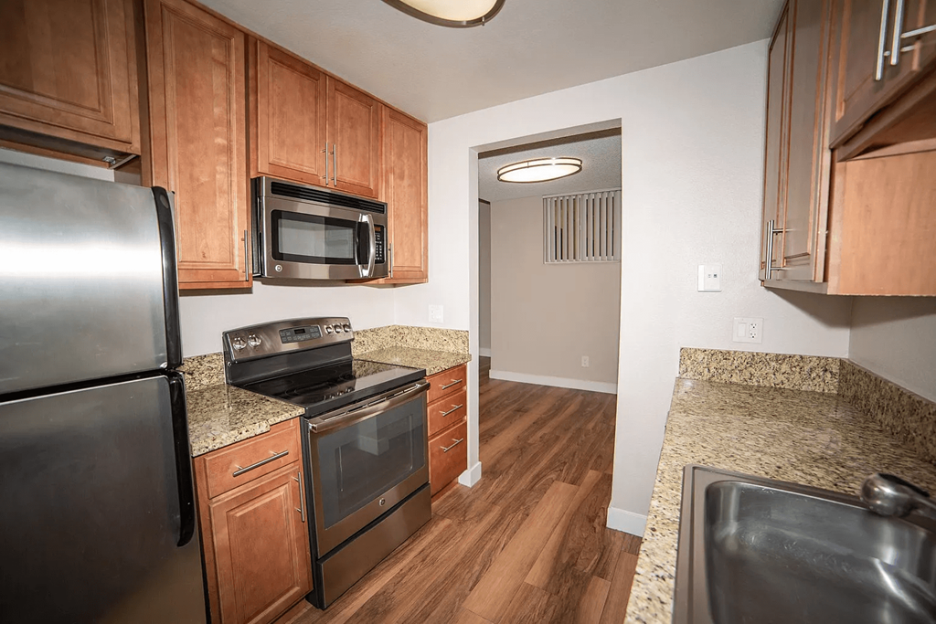 a kitchen with stainless steel appliances and granite counter tops