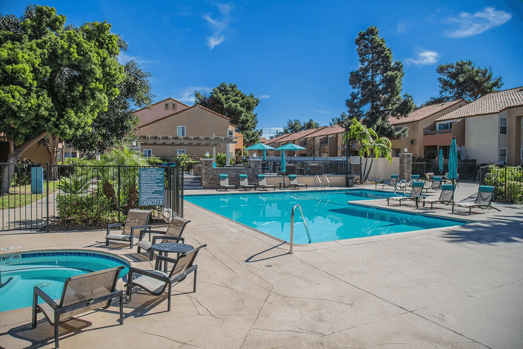 our apartments have a swimming pool with chairs and umbrellas