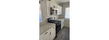 a kitchen with a stove and a microwave