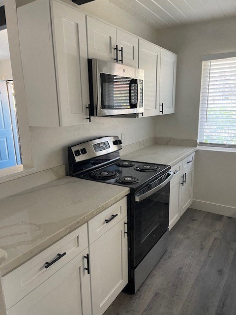 a kitchen with a stove and a microwave