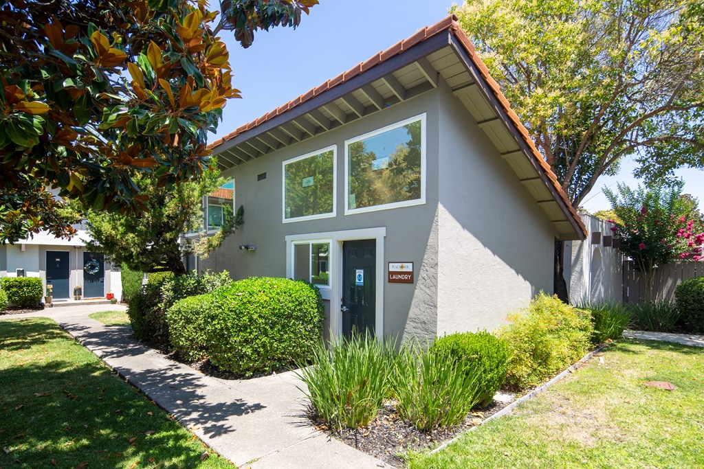 the front of a house with a sidewalk in front of it