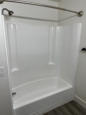 a white bath tub sitting next to a shower curtain
