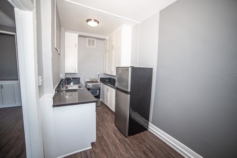 a kitchen with a refrigerator and a sink in a small apartment