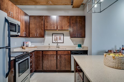 A kitchen with wooden cabinets and a white countertop.