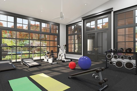 A home gym with exercise equipment and a view of the backyard.