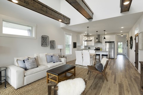 A modern living room with a white couch and a wooden coffee table.