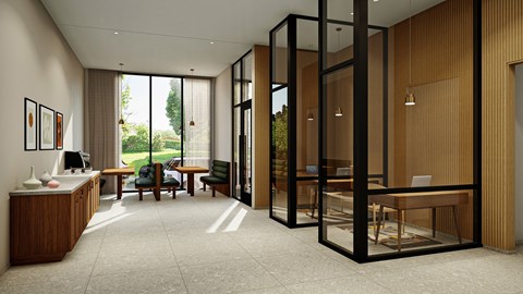 A modern office space with a glass partition wall and a view of the outdoors.