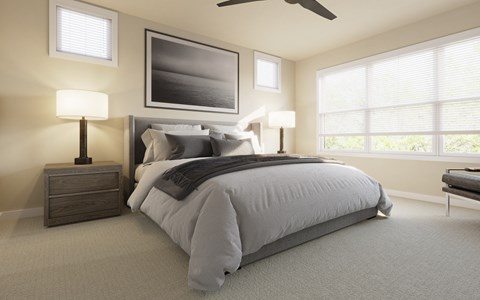 A bedroom with a large bed, a ceiling fan, and a painting on the wall.