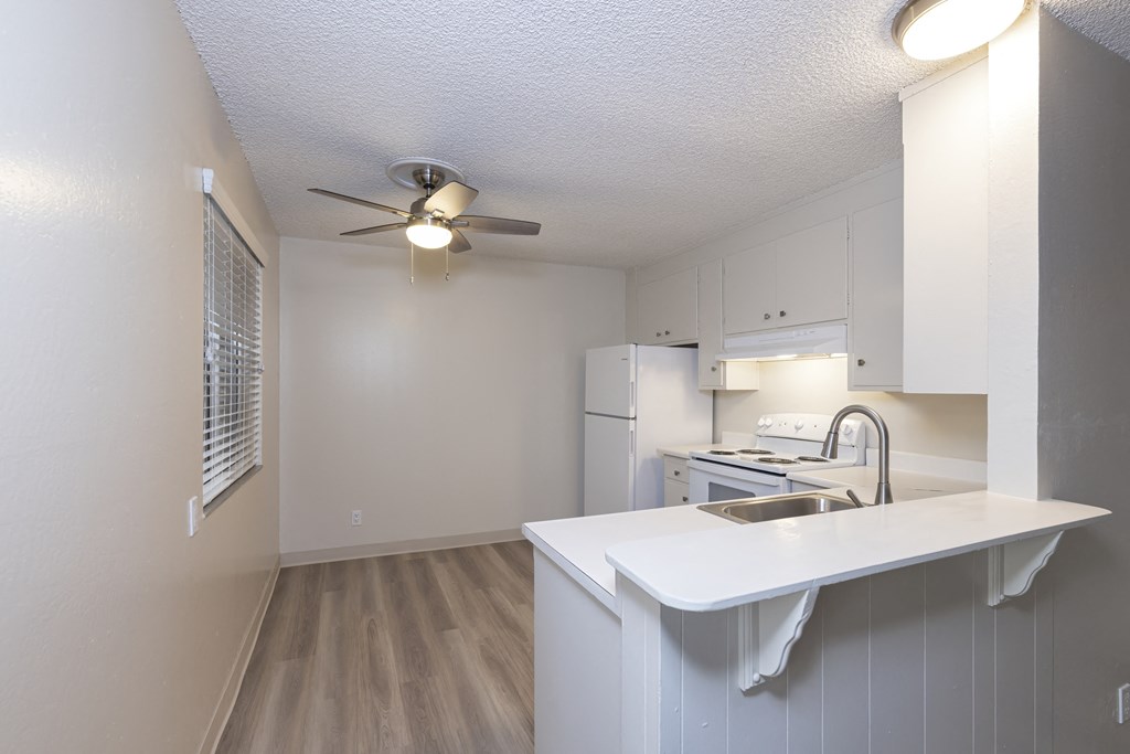a kitchen with white cabinets and a white counter top